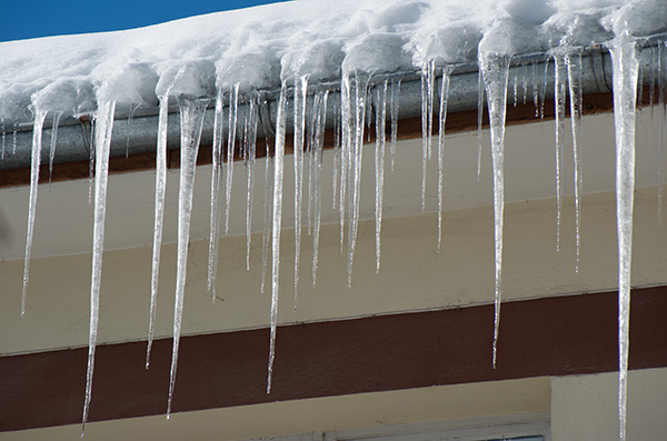 Ice dam forming along the gutter of a roof.