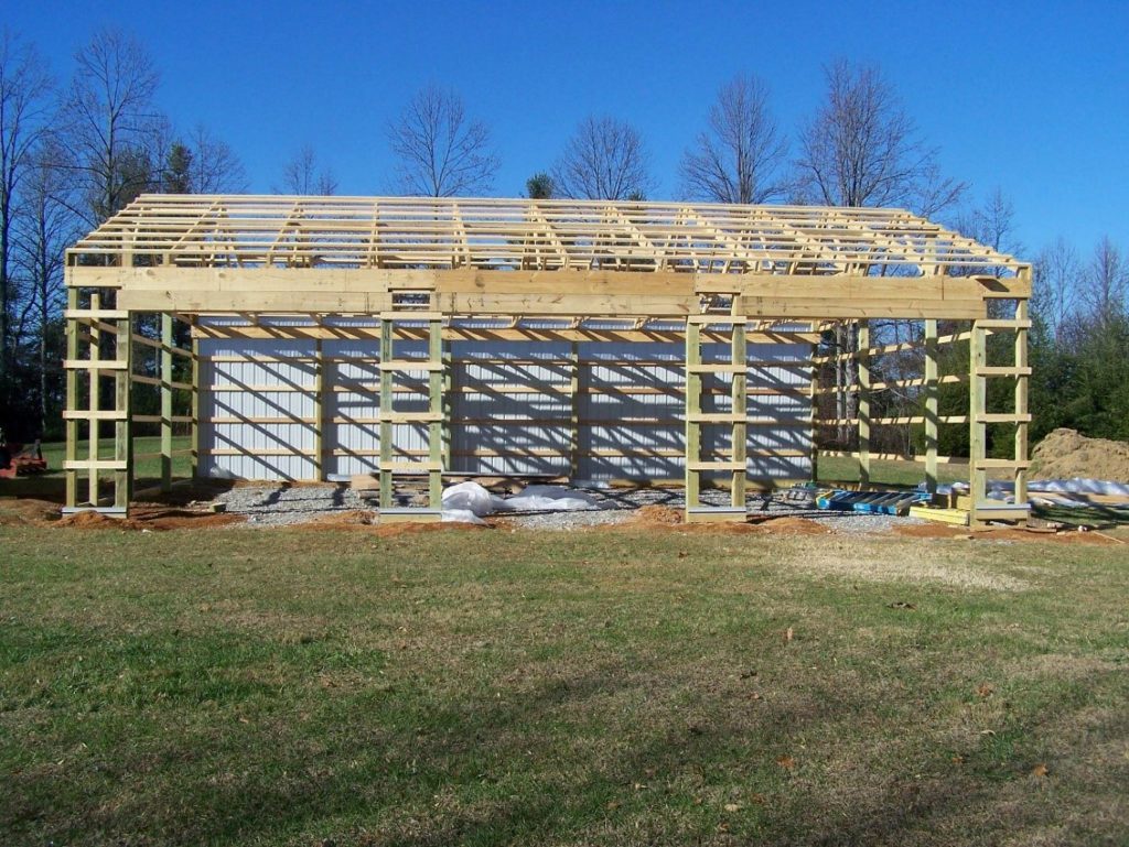 DIY Pole Barn in construction with visible pole barn posts.