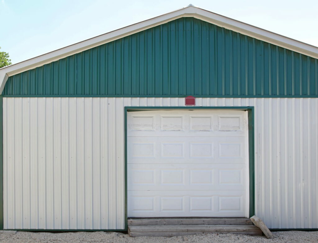 A closed pole barn with a white door