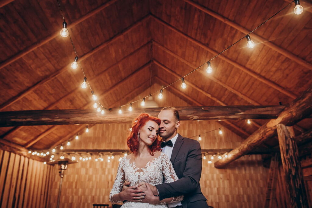 a couple having their wedding party in a pole barn